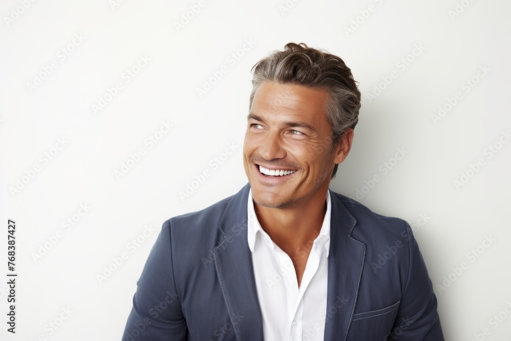 Portrait of a happy young businessman smiling and looking at camera.