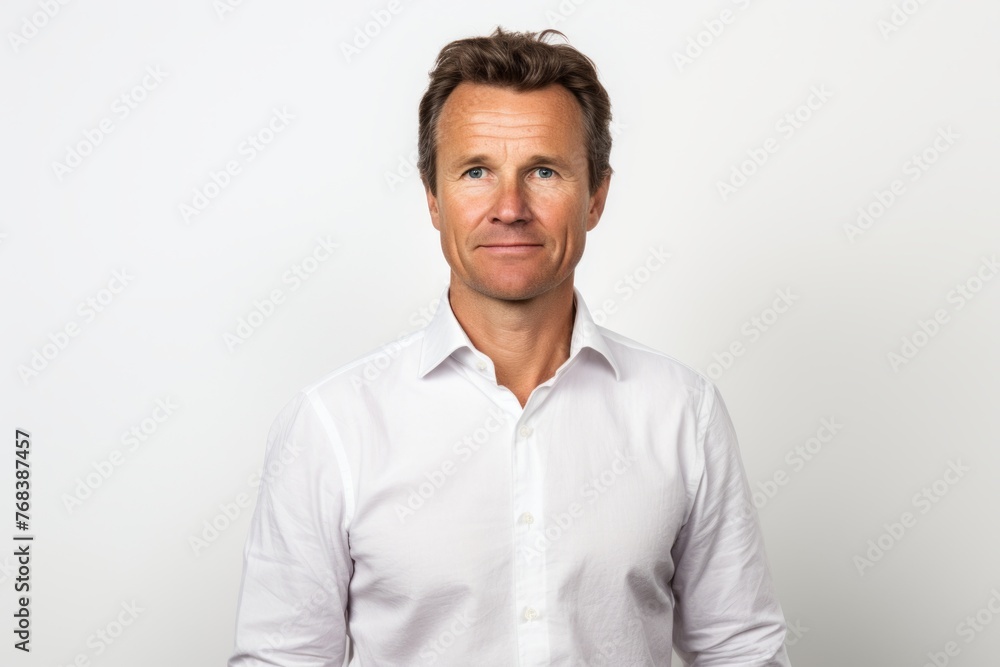 Handsome middle aged man in white shirt looking at camera. Handsome middle aged man in white shirt looking at camera.