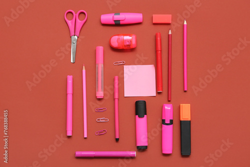 Different stationery on red background. Top view