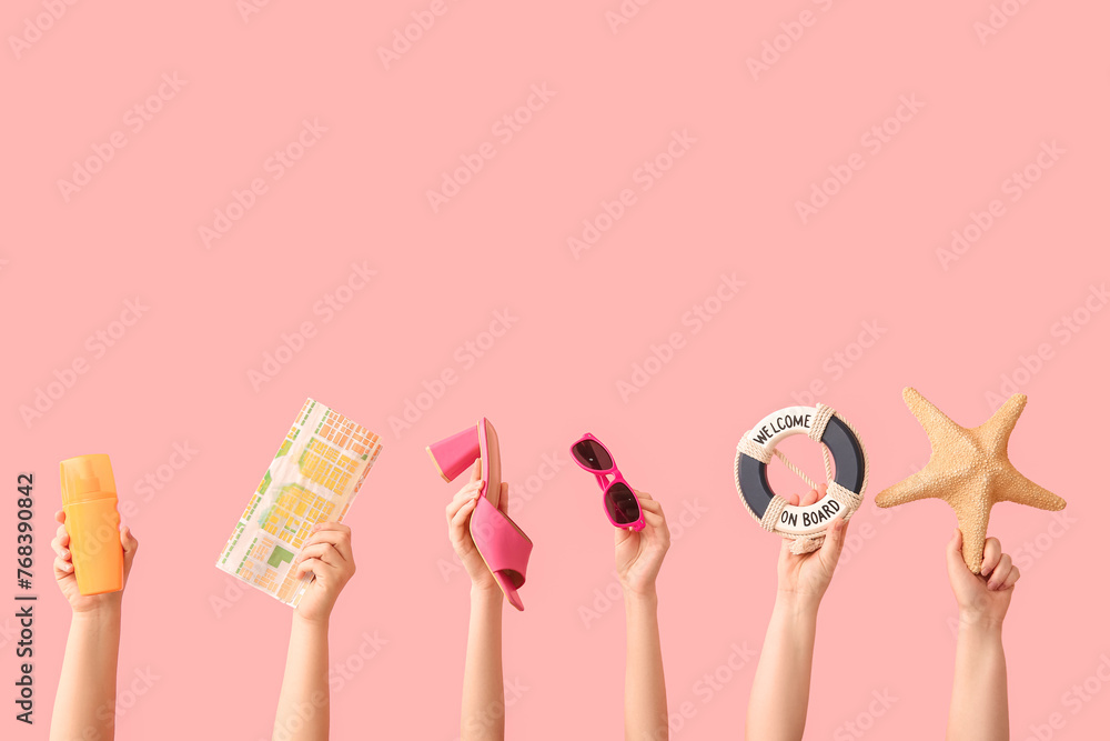 Female hands with starfish, sunglasses, sunscreen, map,  decorative lifebuoy and heeled sandal on pink background. Travel concept. - obrazy, fototapety, plakaty 