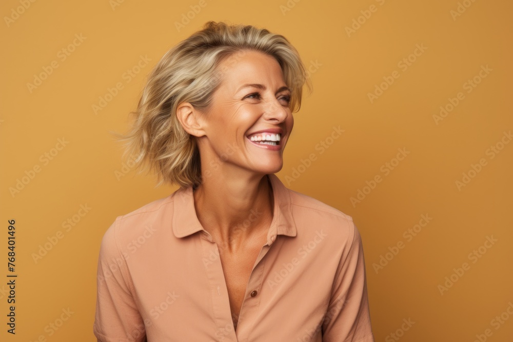 Cheerful mature woman with short blond hair. Portrait of happy mature woman looking at camera. Cheerful mature woman with short blond hair. Portrait of happy mature woman looking at camera.