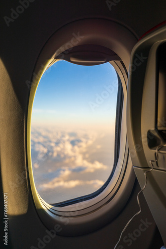 Background of airline window. Beautiful blue sky  white cloud via a plane window. Good idea for inflight accessories  services  interior design. Time passes in the blink of an eye when travelling
