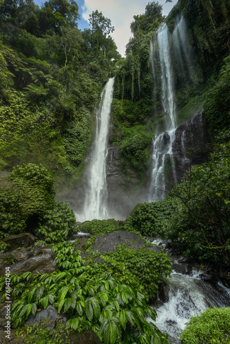 Famous scenic Sekumpul waterfall flowing in the majestic alley of tropical forest of Buleleng province  Bali island