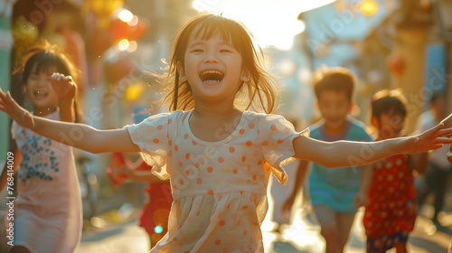 A picture of a little Asian girl on Children's Day, dressed in light colors and grinning broadly as she runs around the streets with other kids in her vicinity. photo