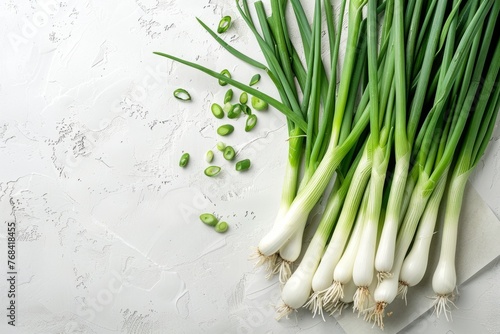 Multiple green onions neatly arranged on a wooden table for a flat lay shot