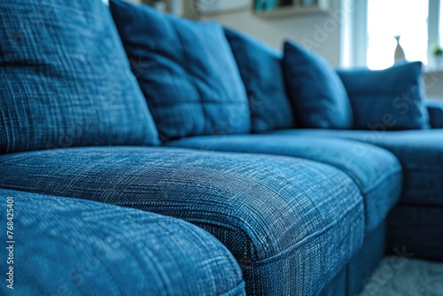 A blue couch with pillows on it © vefimov