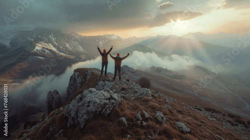 A woman stands on a mountain peak at sunrise, embodying freedom and success, as she looks out over the vast landscape, her silhouette framed against the sky, clouds, and the sun's first light