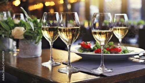 two glasses of champagne on the table  Glasses of white wine served on table in restaurant