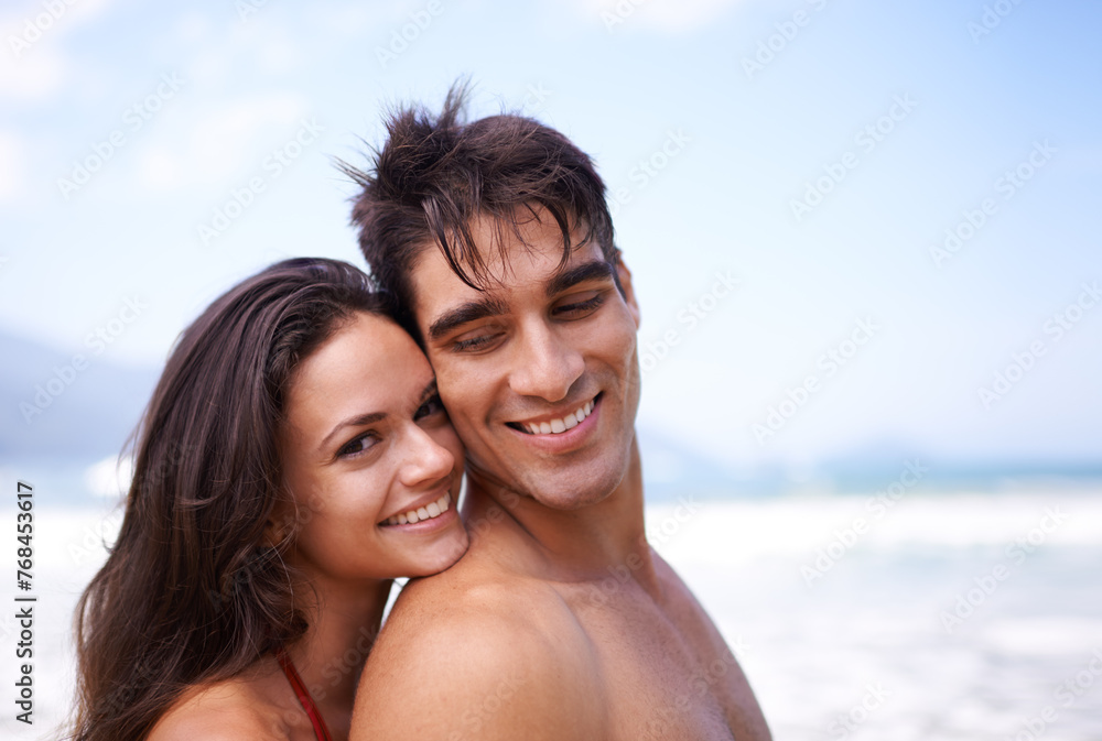 Love, hug and portrait of happy couple at beach for tropical holiday adventure, relax and bonding together. Nature, man and woman smile on romantic date with ocean, blue sky and embrace on vacation.