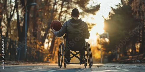 A man in a wheelchair is holding a basketball
