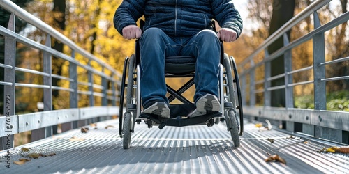 A man in a wheelchair is crossing a bridge photo
