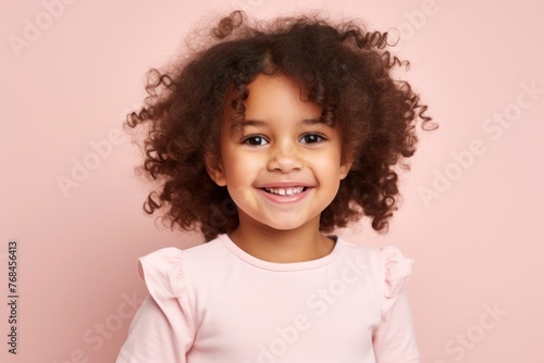 Portrait of a cute little african american girl with curly hair, isolated on pink background © Chacmool