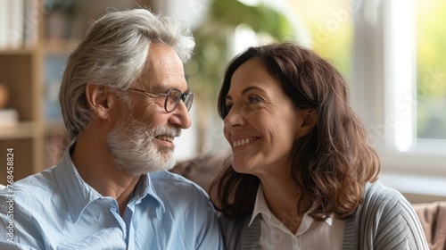 Mature couple sitting in a comfortable office setting,having an engaged discussion with their financial advisor The couple appears relaxed and satisfied,indicating an atmosphere