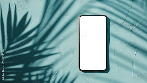 Smartphone with a transparent screen with the shadow of palm leaves isolated on a light blue background.