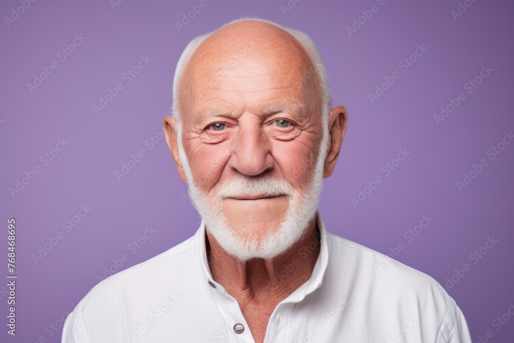 Portrait of a senior man with white beard on purple background. Portrait of a senior man with white beard on purple background.