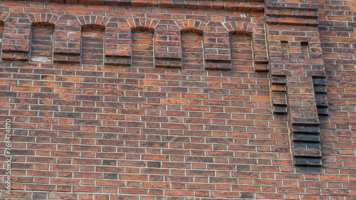 An old red brick building built in the 19th century. The wall of an old red brick house. The brickwork of the old building. Brick background.