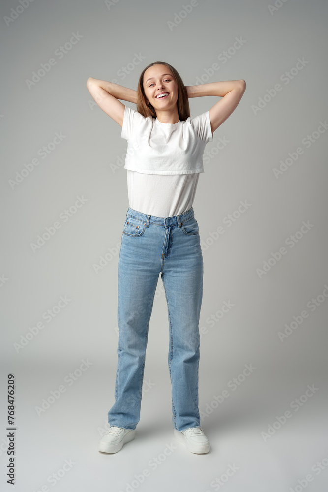 Young happy smiling woman on a gray background Young happy smiling woman on a gray background