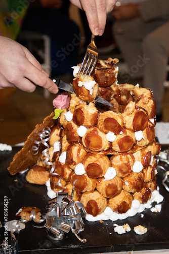 Croquembouche pyramid with caramel glaze on a table