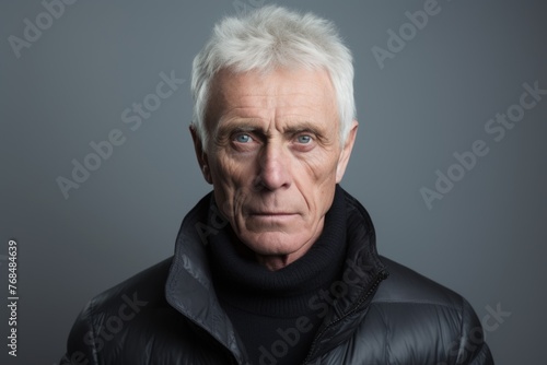 Portrait of a senior man in a black jacket. Studio shot.