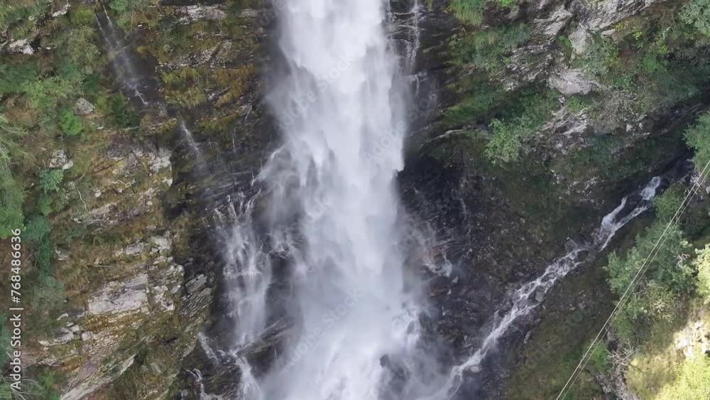 Aerial Pan Up From Side of Tall Waterfall Lodged in Mountains Aerial Pan Up From Side of Tall Waterfall Lodged in Mountains