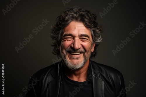 Portrait of a senior man laughing and looking at the camera.