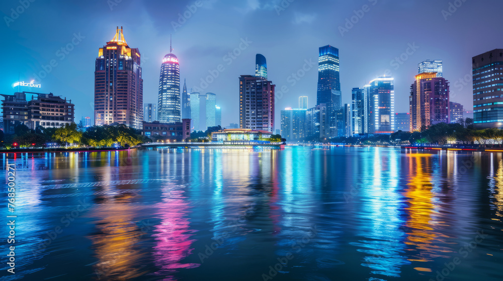 Fototapeta premium The city comes alive at night with building lights reflecting off the water, creating a lively urban scene