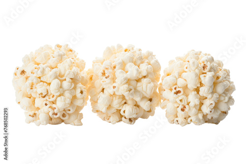 Three individual pieces of popcorn. Each kernel shows its unique shape and texture, with visible variations in size and color. Isolated on a Transparent Background PNG.
