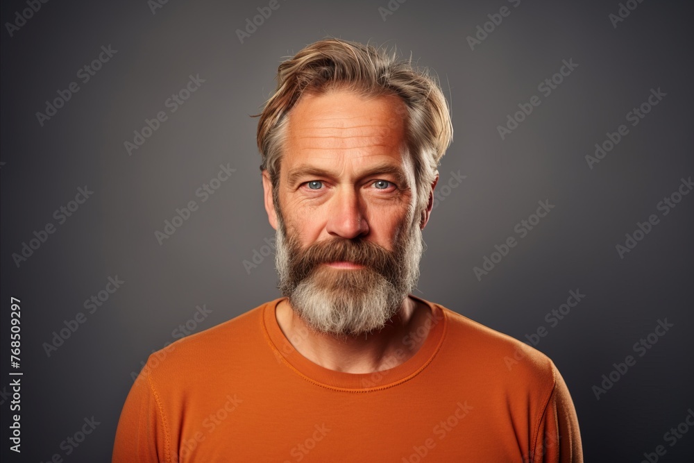 Handsome mature man with long grey beard and mustache. Studio shot.