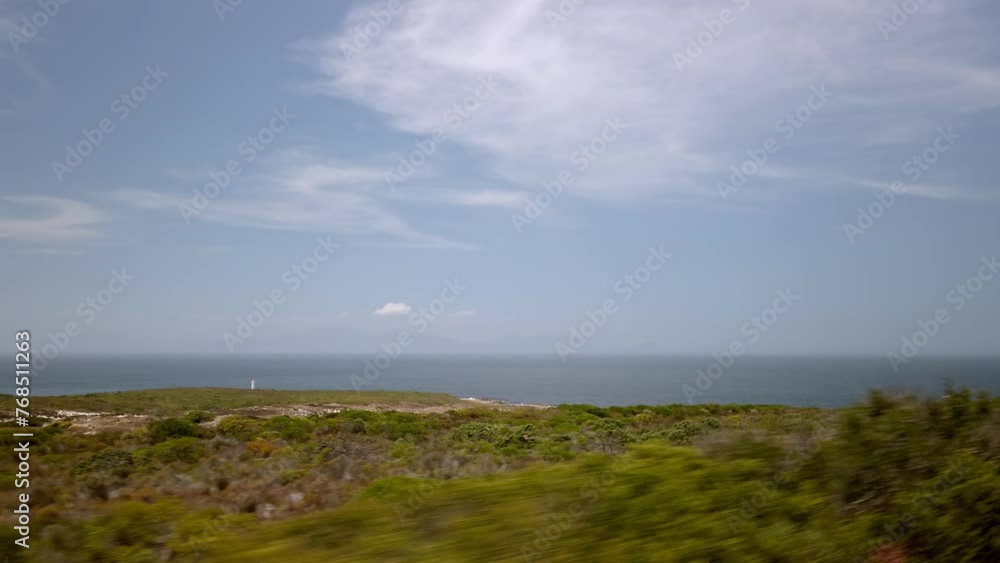 Driving through cape of new hope point of view inside car agricultural fields of south African countryside, skyline and ocean background in sunny daylight Driving through cape of new hope point of view inside car agricultural fields of south African countryside, skyline and ocean background in sunny daylight