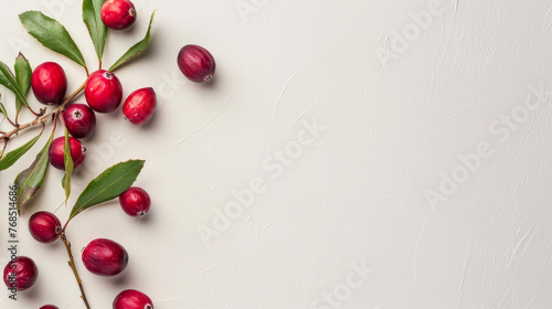 Red cranberries scattered on a white plain background.