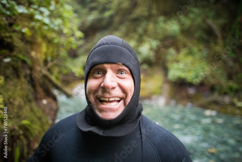 Portrait of man in wetsuit making a happy funny face
