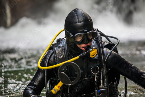 Portrait of scuba diver holding a small metal detector photo