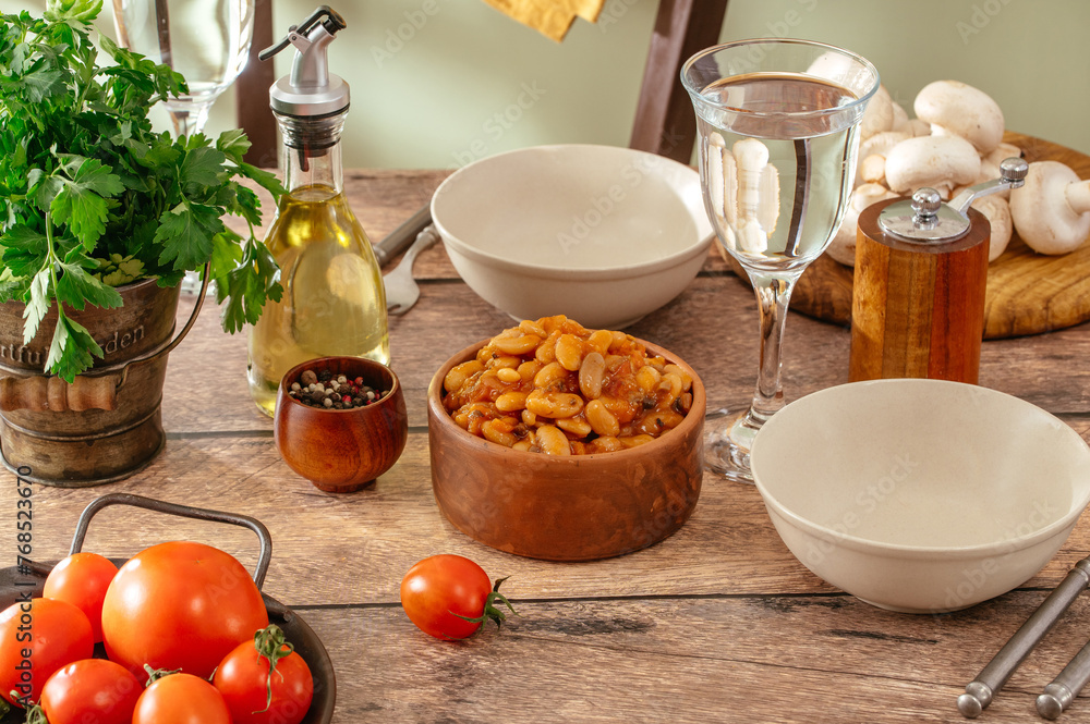 beans in tomato sauce on the table in a bowl beans in tomato sauce on the table in a bowl