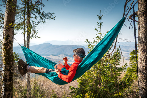 Man Lying on Hammock in Mountain Range photo
