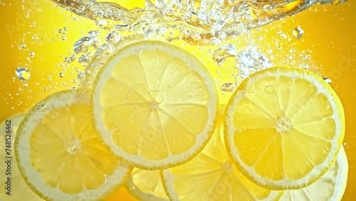 Super Slow Motion Shot of Fresh Lemon Slices Falling and Flowing in Water at 1000 fps.