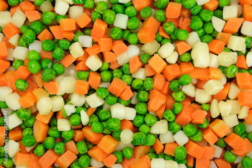 Raw diced vegetables including carrot peas potato and peas background. Different cubes of vegetables.  