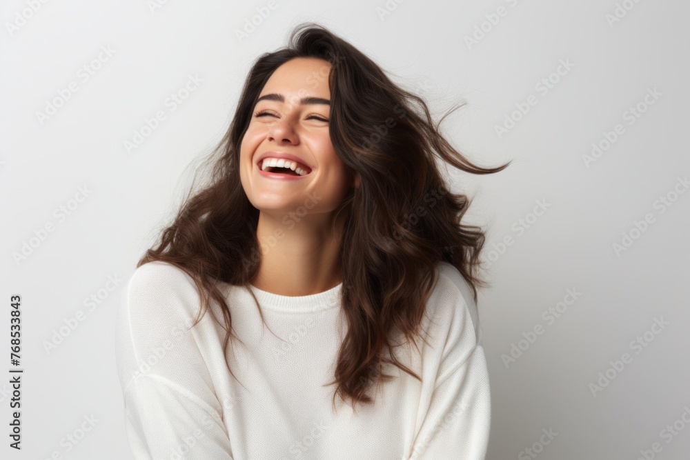 Portrait of a beautiful young woman laughing with closed eyes, white background Portrait of a beautiful young woman laughing with closed eyes, white background