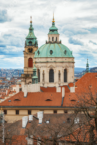 Panorama of old historic town Prague in Czech Praha, view from castle hill in sunny day, in front Church of Saint Nicholas. Central Bohemia, Czech Republic
