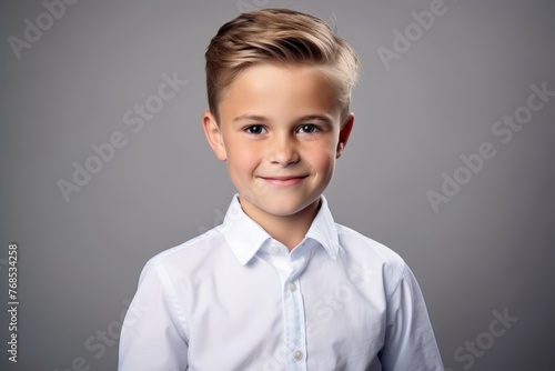 Portrait of a cute little boy in a white shirt. Studio shot.