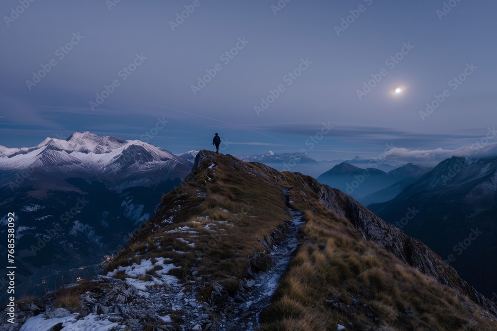 lone traveler on a mountain ridge, moon illuminating the path ahead
