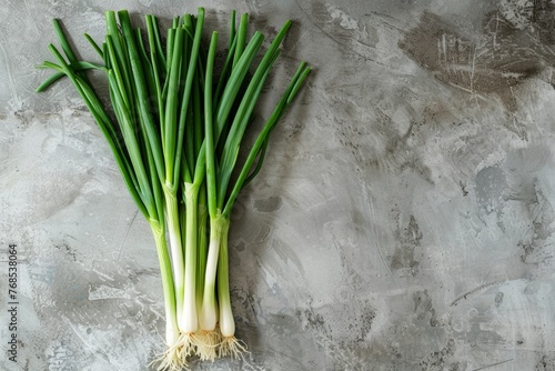 A top-down view of a bunch of green onions neatly arranged on a table