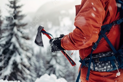 hiker attaching ice axe to backpack against snowy backdrop
