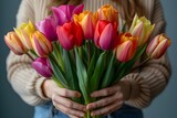 Woman Holding a Bouquet of Colorful Tulips