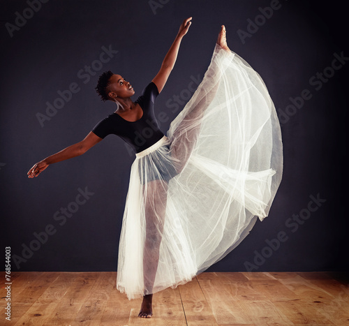 Ballet, black woman and ballerina in studio for dance routine, training and performance. Contemporary, dancing and young female person for elegant art, movement and practice with dark background