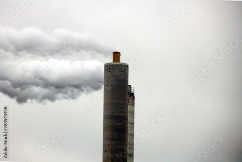 Steam and polluting smoke rises from the chimney of waste incinerator AEB in Amsterdam photo