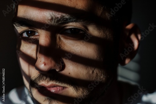closeup of a mans face partially hidden by shadows