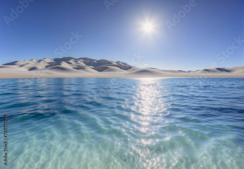Gentle waves ripple across a clear body of water under a bright sun, with rolling sand dunes under a clear blue sky. The sun's reflection sparkles on the water, lending a serene mood to the scene.