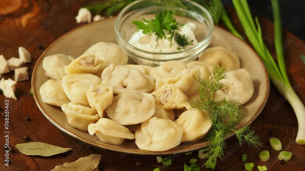 Dumplings with meat in a plate on the table. Traditional food. Ravioli, manti, dumplings are a type of dough with meat. Mysnye freshly cooked handmade dumplings. Dumplings with meat in a plate on the table. Traditional food. Ravioli, manti, dumplings are a type of dough with meat. Mysnye freshly cooked handmade dumplings.