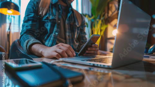 Man Booking Hotel via Laptop and Smartphone