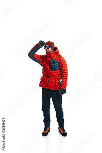 Outdoor apparel ad showcasing the warmth and versatility of climbing gear. Man in jacket with backpack isolated on white background. Concept of active lifestyle, tourism, mountaineering, sport, travel © master1305